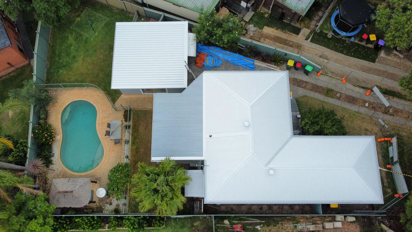 Aerial view of a house with a swimming pool.