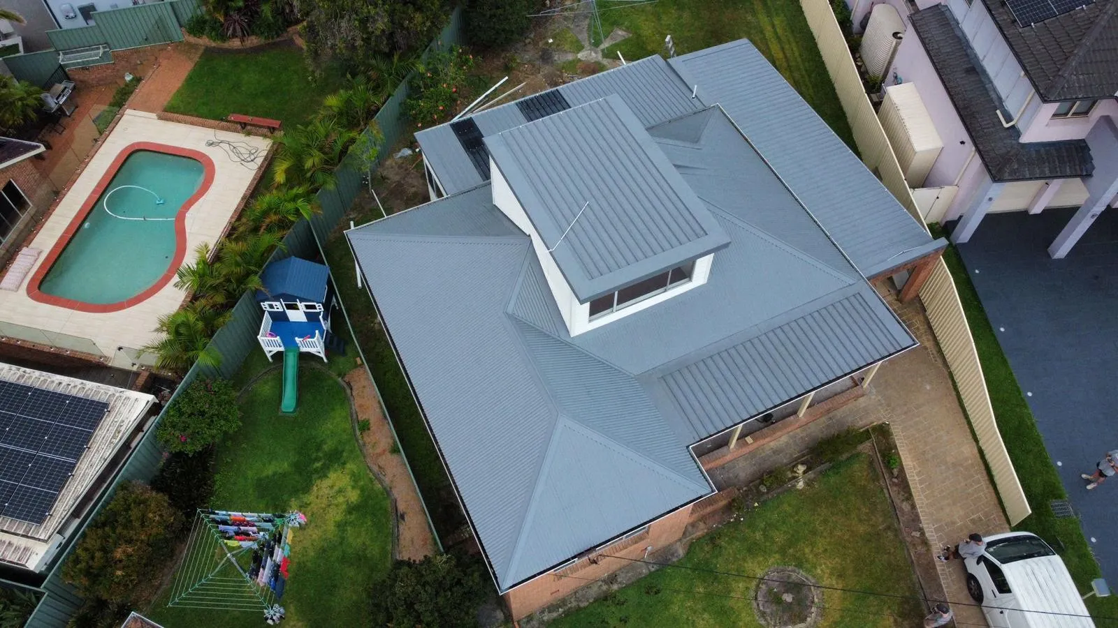 Aerial view of house with backyard pool.