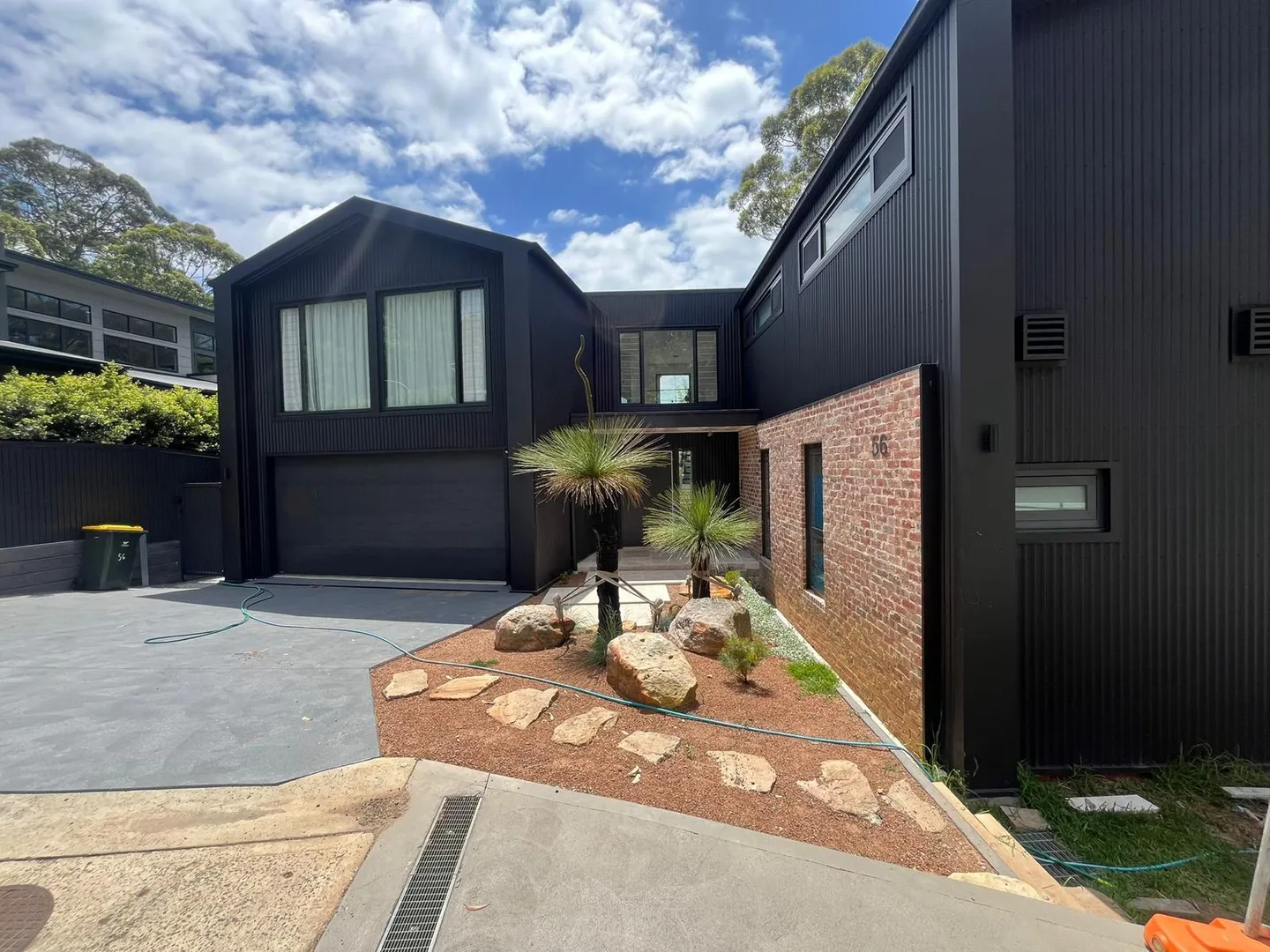 Modern black house with landscaped entrance