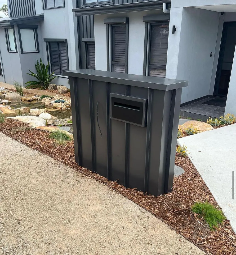 Modern mailbox in front of apartment building