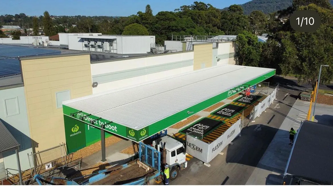 Store rooftop view with solar panels and greenery.